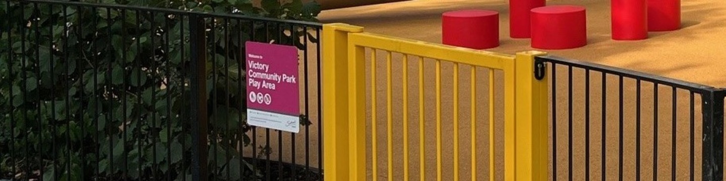 Image of a gate and sign outside a play area 