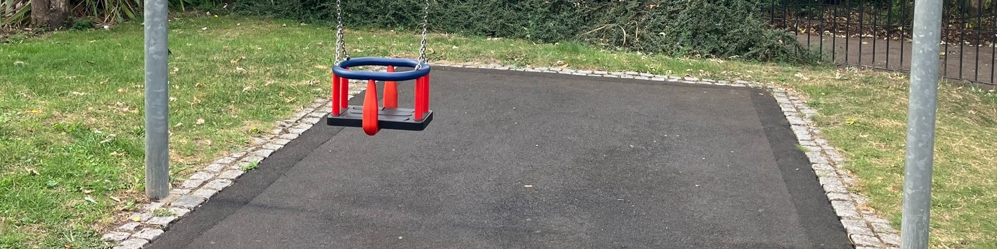 View of one toddler swing, the other one is missing.