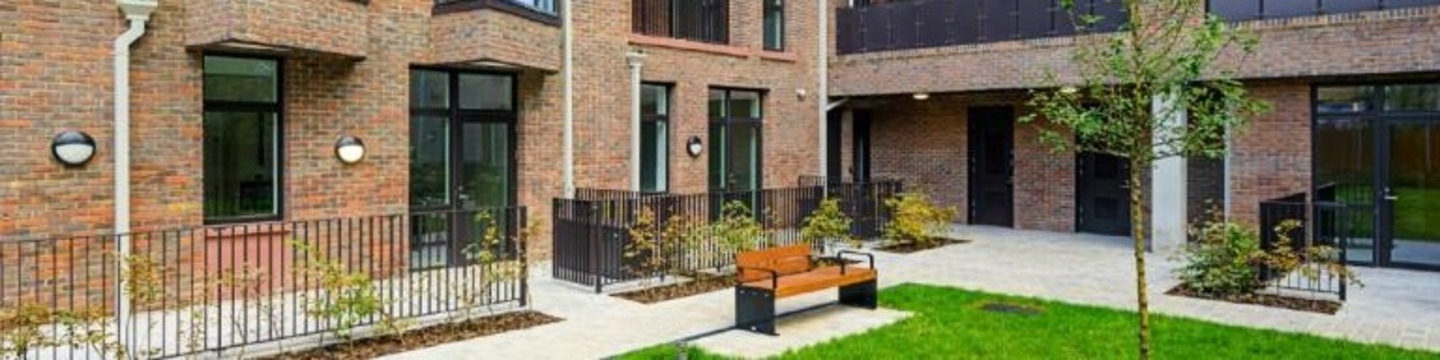 A bench in front of a block of flats