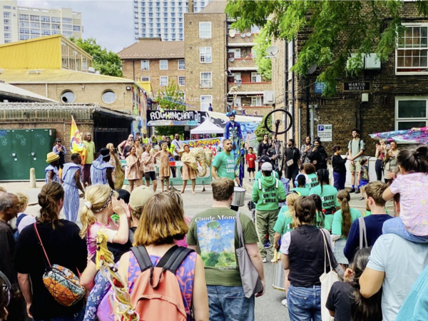 image of people gathered on forecourt watching entertainers at RockiFest